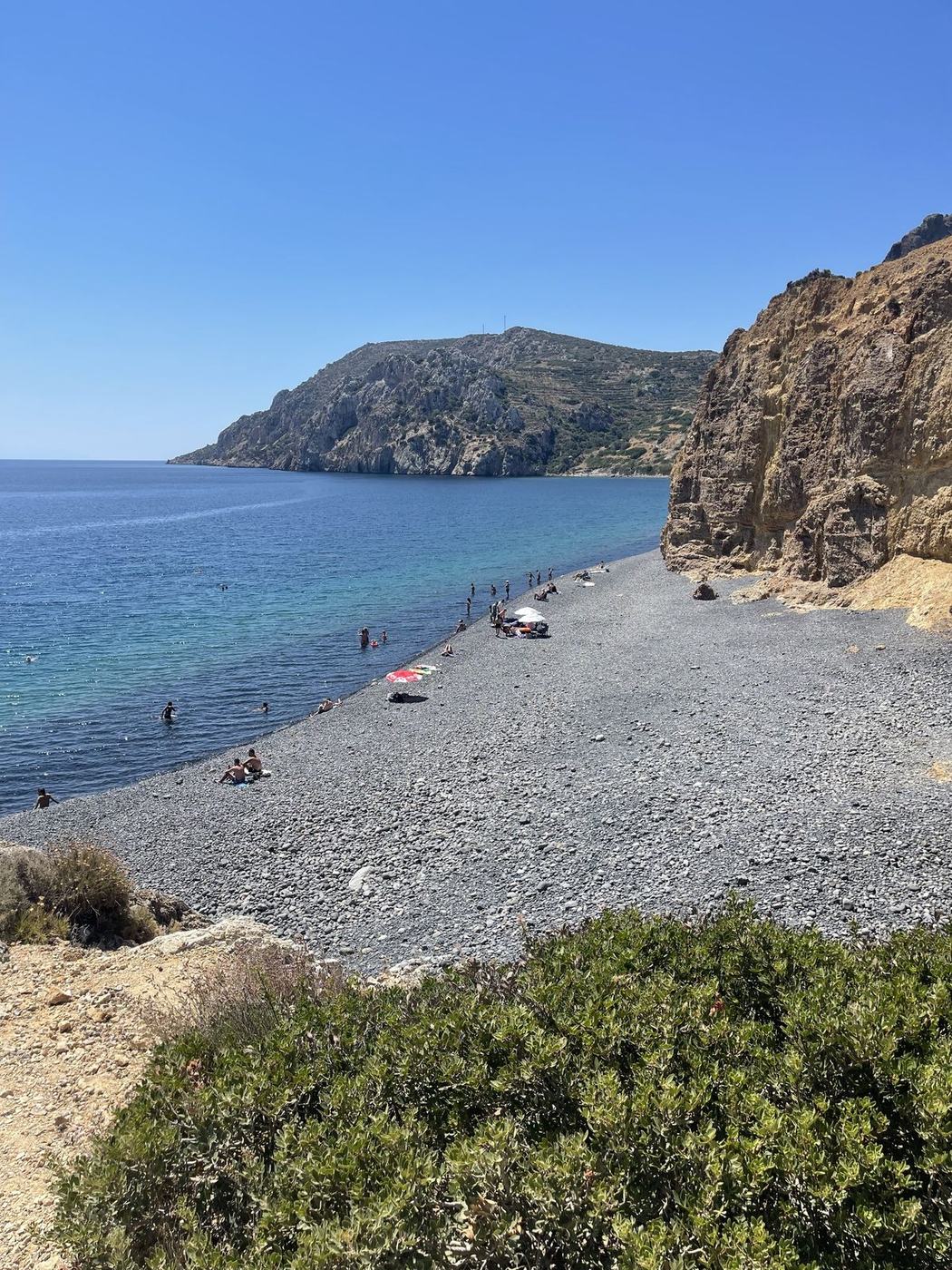 Curve of a pebble beach below a headland