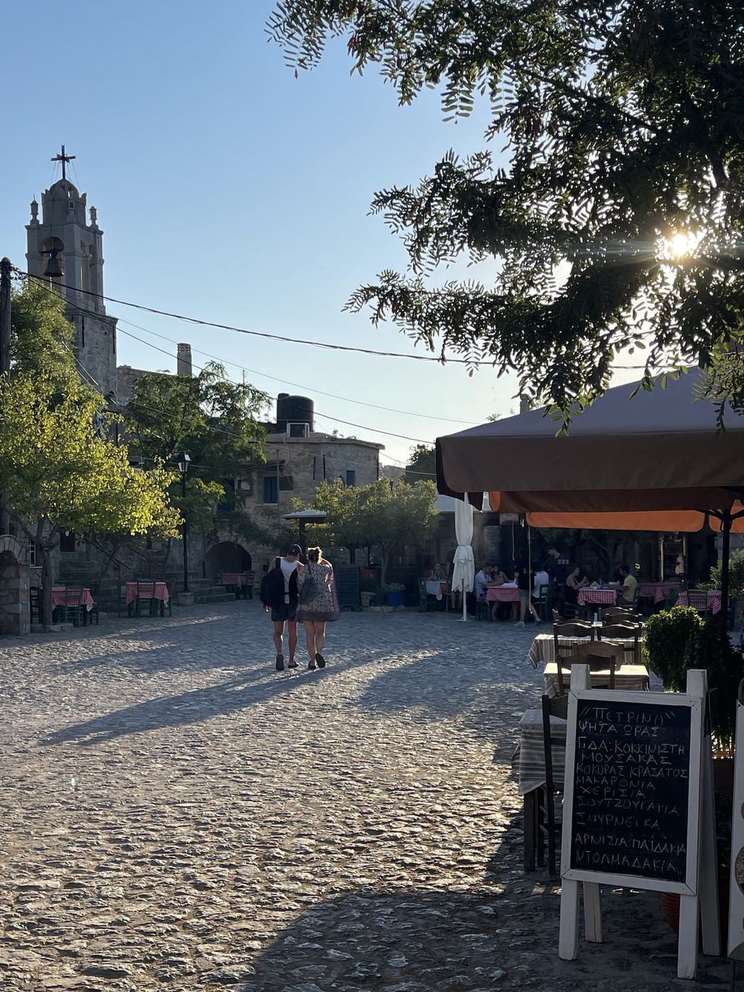 Village square with church tower and taverna