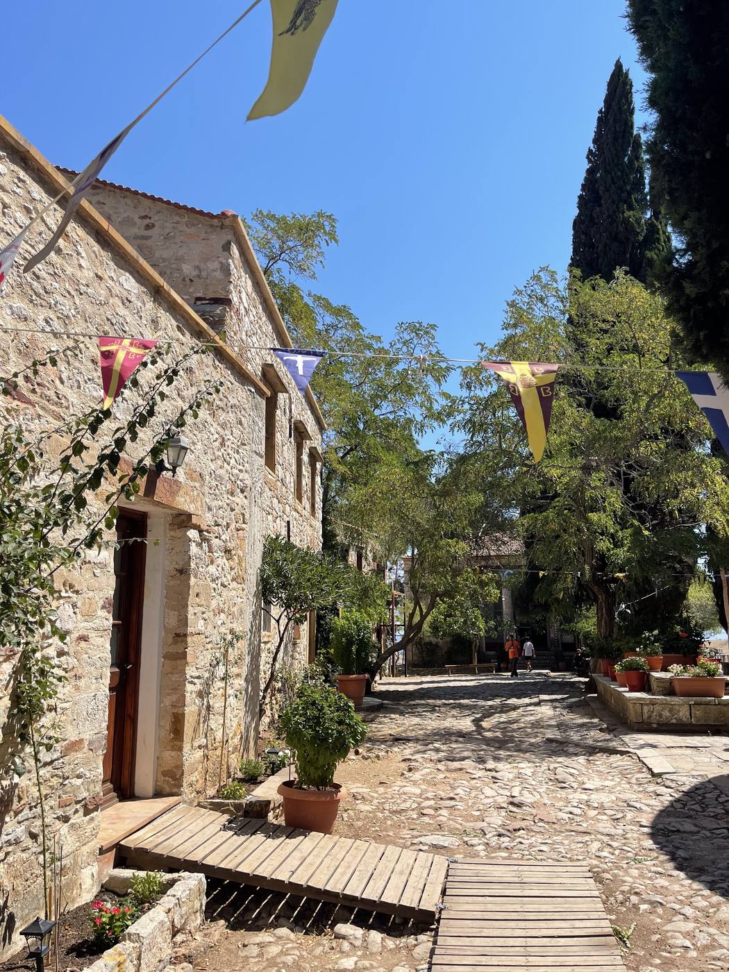 Stone buildings and cypresses inside the monastery walls