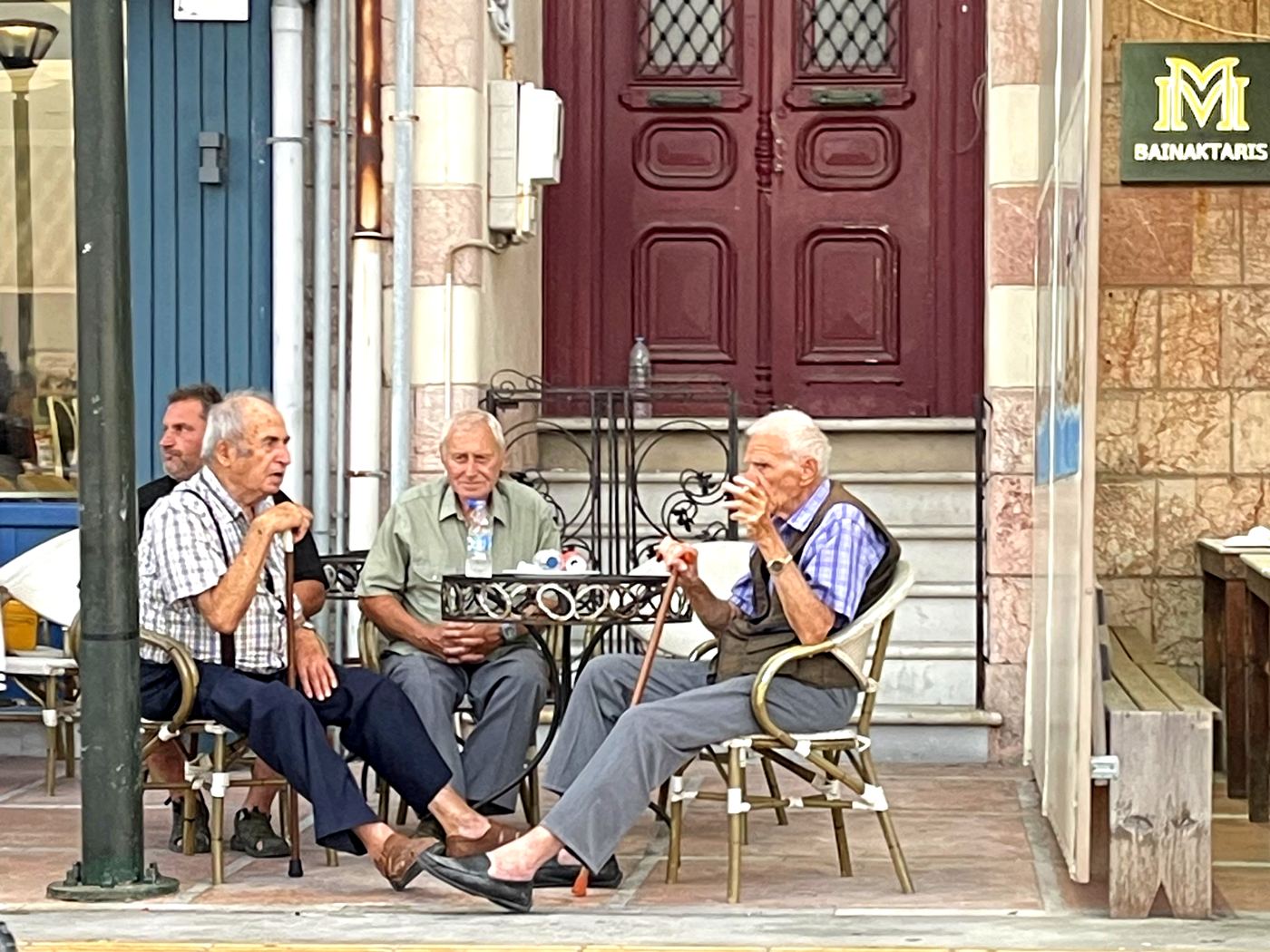 Local men drinking coffee outside a cafe in Chios town