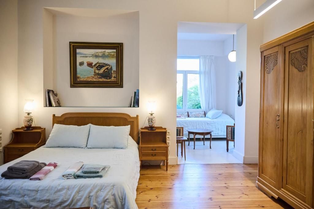 Bedroom with high ceilings and shutters